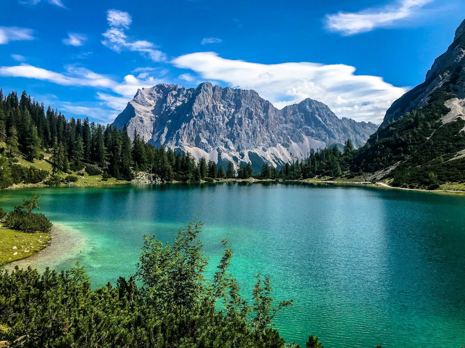 Glacial lake and mountains under blue sky